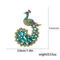 Colorful peacock brooch with sparkling crystals and alloy base on white background - Green