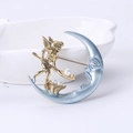 Macro detail of vintage matte gold sun and moon brooch with pearl accents - Gold