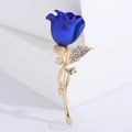 Elegant blue rose brooch with gold stem and rhinestones on a minimalist background - Blue