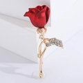 Elegant red rose brooch with gold stem and sparkling crystals on a white background - Red