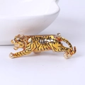 Detailed back view showing the metal pin of a gold tiger brooch with black enamel - Yellow