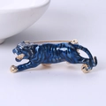 Detailed view of jumping tiger brooch with blue enamel inlay and golden alloy details - Blue