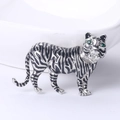 Silver tiger brooch with black enamel stripes and green zircon eyes on white background - Silver