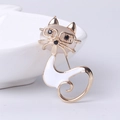 Cat brooch with cat eye stone and white enamel finish in a minimalist gold setting - White