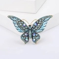Elegante vintage vlinderbroche van goudkleurige legering met blauwe kristallen en strass - Meerblauw