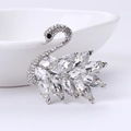 Elegant silver swan brooch with clear crystal inlay on a minimalist white ceramic bowl - MM-BR-2590 Silver