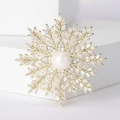 Elegant gold snowflake brooch with a large central pearl and sparkling zircon accents - Gold