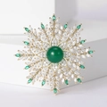 Detailed view of snowflake brooch with green gemstone and white cubic zirconia accents - Green Pearl