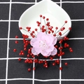 Handmade pink chiffon flower brooch with red faceted beads and crystals on a white plate - Red