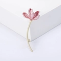 Close-up of pink enamel magnolia brooch with gold stem on a white geometric stand - Pink