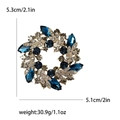 Baroque crystal flower wreath brooch with blue and smoke-colored gemstones and gold base - Blue