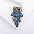 Vintage owl brooch featuring dark grey metal with blue marquise crystals and sparkling diamonds - Blue (2734)