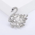 Sparkling silver swan brooch with marquise-cut crystals on a white pedestal - White