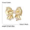 Gouden strik parelbroche met 3,1 cm hoogte en 3,6 cm breedte voor kostuumjasjes - Goud