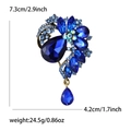 Detailed macro view showing the 7.3cm height and 4.2cm width of the blue crystal brooch - Blue