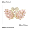 Elegant twin swan brooch with micro-pave cubic zirconia and pink crystal wings - Pink