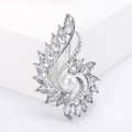 Macro view of a silver-tone alloy brooch with white pearl and marquise crystal petals - Silver