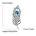 Broche plume vintage avec cristaux colorés et strass bleu sur alliage d'argent - Argenté
