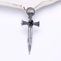 Macro detail of gothic sword brooch with black stone and rhinestones on white background - Silver