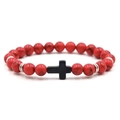 Detailed view of 8mm red agate beads and black cross pendant on a beaded bracelet - Red Turquoise With Black Cross