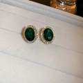 Macro shot of oval emerald green stud earrings with halo diamond set in gold metal - Regular Green Oval (27# Silver Earring Post)