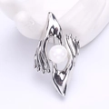 Unique silver brooch featuring interlocking hands holding a white pearl on a white background - Silver