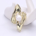 Artistic gold hand brooch holding a white pearl for elegant suit styling accessories - Gold