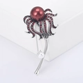 Dettaglio della spilla a dente di leone con perla rosso scuro e cristalli scintillanti - Rosso