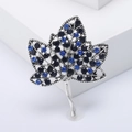 Vintage silver maple leaf brooch with blue rhinestones and hollow leaf structure - Blue