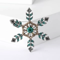 Dettagli della spilla a fiocco di neve argentata con cristalli verdi e color champagne - Verde