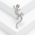 Macro shot of silver gecko brooch with sparkling white and iridescent rhinestones - White