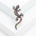 Detailed macro view of an ornate gecko brooch with vibrant multi-colored crystal rhinestones - Colorful