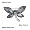 Elegant dragonfly brooch with grey crystals and green gems on a silver metal base - Gray (2946-GY)
