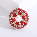 Detail of red pearl wreath brooch with gold flower accents and sparkling rhinestones - KC Gold Red Pearl