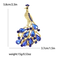 Élégante broche paon dorée avec strass bleus et dimensions de 5,8 cm sur 3,7 cm - Bleu