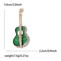 Elegant gold guitar brooch with emerald enamel and rhinestones on white background - Green (3180-GN)