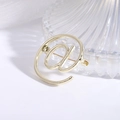 Detailed close-up of golden alloy @ symbol brooch with a metallic pin on a white surface - Gold