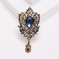Vintage palace style crystal glass brooch with teardrop blue stone in gold filigree - Dark Blue