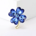 Detailed macro view of four-leaf clover brooch with blue heart crystals and gold finish - Heart Clover (3187) / Blue
