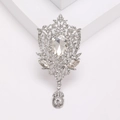 Macro shot of large vintage royal style brooch with crystals and pear shaped pendant - Silver