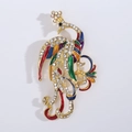 Close-up of vintage phoenix brooch with colorful enamel details and white rhinestones - Colorful