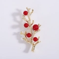 Macro detail of golden coral branch brooch with red beads and micro-set cubic zirconia - Red (8389)