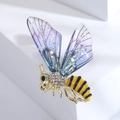 Detail of bee brooch with purple gradient wings and sparkling rhinestones on gold metal - Purple
