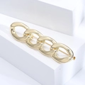 Detailed close-up of golden Cuban chain brooch with polished links and back pin detail - Gold