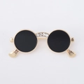 Detail view of retro sunglasses brooch with gold frame, black lenses and crystal inlay - Gold