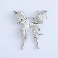 Detail of silver liquid metal butterfly brooch with a smooth melted lava texture - Silver