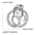 Silver snake brooch with sparkling rhinestones and dimension markers for scale - White