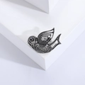Detailed view of a vintage hollow pigeon brooch with retro silver metal and black stone eye - Silver