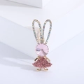 Detail of pink crystal rabbit brooch with sparkly rhinestones on a golden base - Pink