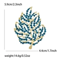 Leaf brooch with blue rhinestones in gold finish, dimensions 5.9cm height by 4.4cm width - Blue (3366-BL)
